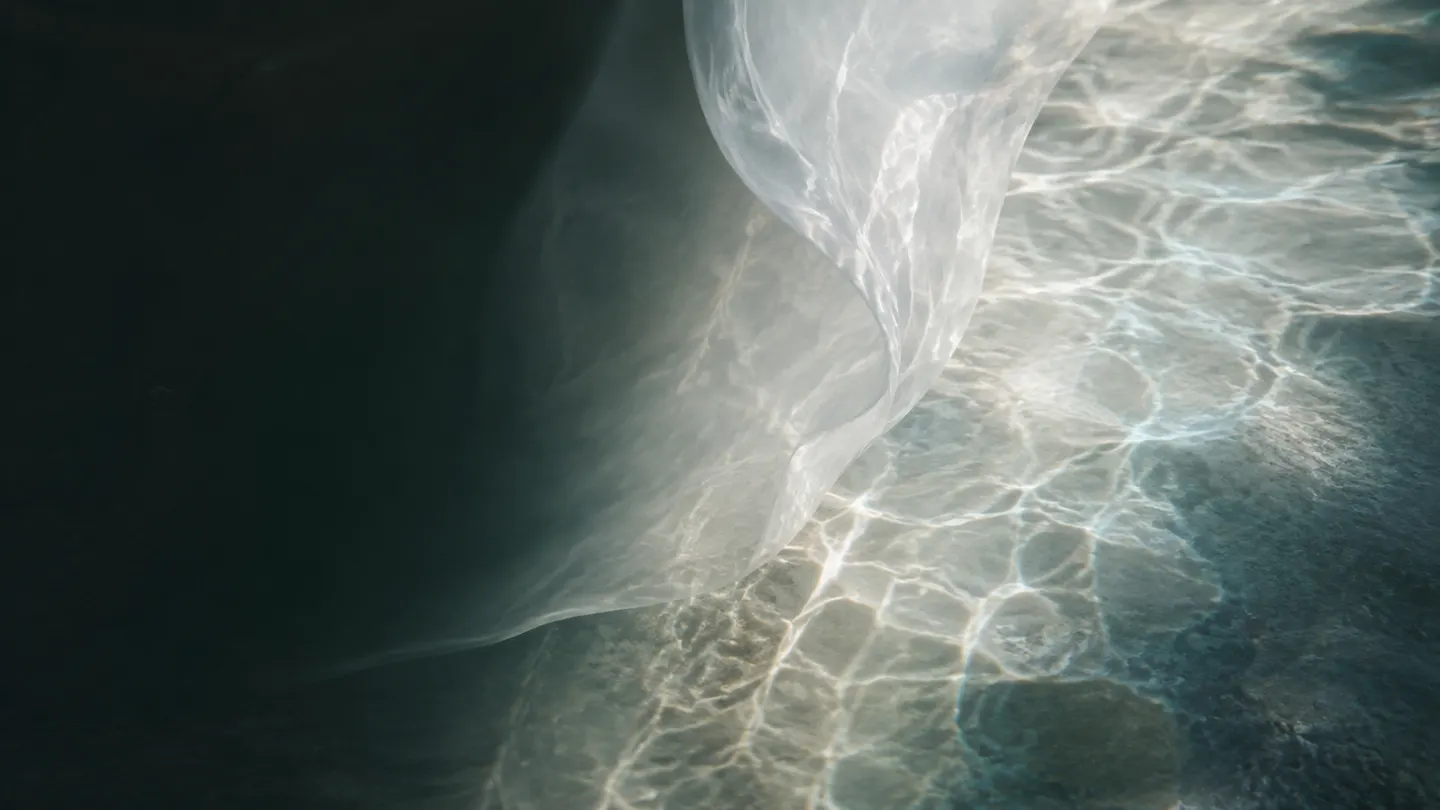A translucent membrane and clear water shaping luminous moving light